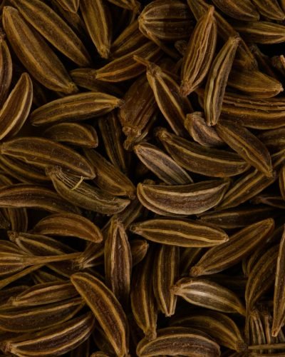 Detailed close-up of brown caraway seeds, ideal for spice and culinary themes. Perfect for food-related content.